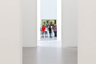 Museum, Blick durch mehrere Räume, ganz hinten stehen Schüler vor einem Gemälde